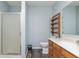 Bathroom featuring a sink, vanity, toilet, shower with glass doors and wood shelving for storage at 1000 Janet Dr, Greenwood, IN 46142