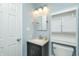 Bathroom featuring a sink, vanity, toilet, mirror, and white cabinet above the toilet with storage at 1000 Janet Dr, Greenwood, IN 46142