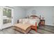 Comfortable bedroom with a king-sized bed, an outside exit, and a decorative bench at the foot of the bed at 1000 Janet Dr, Greenwood, IN 46142