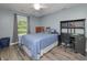 Bedroom featuring a bed with blue sheets, a desk, and a window with bright sunlight at 1000 Janet Dr, Greenwood, IN 46142