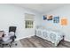 Bedroom with window, single bed with blue and white patterns, chair, and art on the walls at 1000 Janet Dr, Greenwood, IN 46142