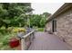 Charming wooden deck adorned with vibrant flowers and decor, perfect for enjoying the outdoor scenery at 1000 Janet Dr, Greenwood, IN 46142