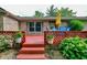 A cozy outdoor deck with flowers, chairs, and umbrella at 1000 Janet Dr, Greenwood, IN 46142