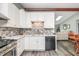 Modern kitchen with white cabinets, stylish backsplash, and stainless steel appliances at 1000 Janet Dr, Greenwood, IN 46142