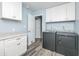 Laundry room featuring white cabinets with washer, dryer, countertop, and doorway to another room at 1000 Janet Dr, Greenwood, IN 46142