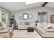 Sunlit living room featuring plush seating, skylights and neutral decor at 1000 Janet Dr, Greenwood, IN 46142
