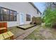 Backyard features a door leading to small deck area, brick pavers, and yard space at 1012 S Montgomery Rd, Greenwood, IN 46143