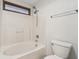 Bathroom featuring a bath and shower combo with white tiling, a toilet and towel rack at 1012 S Montgomery Rd, Greenwood, IN 46143