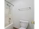 Bathroom with a shower-tub combo, toilet, towel bar and a door with gold hardware at 1012 S Montgomery Rd, Greenwood, IN 46143