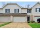 Inviting townhome featuring a brick facade, attached garage, and well-maintained landscaping at 1012 S Montgomery Rd, Greenwood, IN 46143