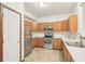 Efficient kitchen features stainless steel appliances, wooden cabinets and a view to living area at 1012 S Montgomery Rd, Greenwood, IN 46143