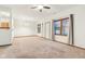 Bright, carpeted living room features a ceiling fan, large windows, and natural light at 1012 S Montgomery Rd, Greenwood, IN 46143