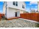 White two-story home featuring a backyard with a wooden deck and fenced-in yard at 1018 Calvary St, Indianapolis, IN 46203