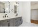 Bathroom featuring double vanity with gray cabinets, black hardware and light fixtures at 1018 Calvary St, Indianapolis, IN 46203