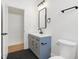 Stylish bathroom with a modern vanity, black hardware, and grey accent colors at 1018 Calvary St, Indianapolis, IN 46203