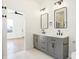 Bathroom with double vanity, stylish mirrors, and modern fixtures at 1018 Calvary St, Indianapolis, IN 46203
