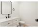 Elegant half bathroom featuring a modern vanity with black hardware and a sleek mirror at 1018 Calvary St, Indianapolis, IN 46203