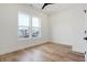 Bright bedroom featuring hardwood floors, white trim, and a window with a view at 1018 Calvary St, Indianapolis, IN 46203