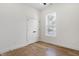 Charming bedroom with hardwood floors, a large window, and double-door closet at 1018 Calvary St, Indianapolis, IN 46203