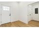 Bright entryway with wood floors, white doors, and access to a closet at 1018 Calvary St, Indianapolis, IN 46203