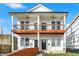 A modern duplex featuring white siding, black trim, and double balconies, creating a stylish and inviting facade at 1018 Calvary St, Indianapolis, IN 46203