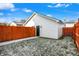 View of a detached two-car garage with a privacy fence and back door at 1018 Calvary St, Indianapolis, IN 46203