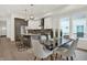 Open-concept kitchen and dining area with stainless steel appliances, a large island, and contemporary decor at 1018 Calvary St, Indianapolis, IN 46203