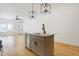 Bright, open kitchen with a sleek island, stainless steel appliances, and a view into the adjacent living space at 1018 Calvary St, Indianapolis, IN 46203