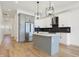 A modern kitchen featuring an island, stainless steel appliances, and stylish pendant lighting at 1018 Calvary St, Indianapolis, IN 46203