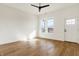 Spacious living room filled with natural light, hardwood floors, and a ceiling fan at 1018 Calvary St, Indianapolis, IN 46203