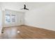 Open living space featuring wood floors, recessed lights, and a bright window at 1018 Calvary St, Indianapolis, IN 46203