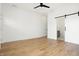 Main bedroom with hardwood floors, ceiling fan, and an en suite bathroom at 1018 Calvary St, Indianapolis, IN 46203
