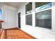 Covered porch with stained wood flooring and white wood paneled walls at 1018 Calvary St, Indianapolis, IN 46203