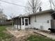 Backyard featuring a screened-in porch and small stone patio area at 1018 E 106Th St, Indianapolis, IN 46280
