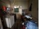 Laundry room with washer, shelving, and supplies, offering functional space at 1018 E 106Th St, Indianapolis, IN 46280