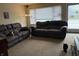 Comfortable living room featuring two sofas, neutral carpet, and a window at 1018 E 106Th St, Indianapolis, IN 46280
