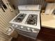 Close-up of the white, four-burner Amana gas stove at 1018 E 106Th St, Indianapolis, IN 46280