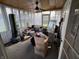 Enclosed sunroom with multiple windows, ceiling fan, and ample natural light at 1018 E 106Th St, Indianapolis, IN 46280