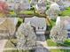 Overhead view of a two-story house with fenced yard and mature flowering trees at 10303 Memorial Knoll Dr, Indianapolis, IN 46234