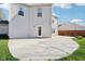 Large concrete patio in backyard, perfect for entertaining, with a grassy area and beige siding at 10303 Memorial Knoll Dr, Indianapolis, IN 46234