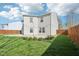 Landscaped backyard featuring a lawn, concrete patio, and wood fence at 10303 Memorial Knoll Dr, Indianapolis, IN 46234