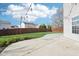 Backyard features a concrete patio, grassy area, and wood fence for privacy at 10303 Memorial Knoll Dr, Indianapolis, IN 46234