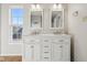 Bright bathroom featuring double vanity, modern lighting, with window allowing for natural light to enter room at 10303 Memorial Knoll Dr, Indianapolis, IN 46234