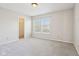 Neutral bedroom with plush carpet, closet, and natural light at 10303 Memorial Knoll Dr, Indianapolis, IN 46234