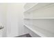A walk-in closet with multiple shelves for storage, and neutral carpeting at 10303 Memorial Knoll Dr, Indianapolis, IN 46234