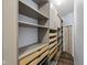 Walk-in closet featuring gray cabinets, drawers, and shelves with wood flooring, offering ample storage space at 10303 Memorial Knoll Dr, Indianapolis, IN 46234