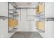 Walk-in closet with carpet flooring and a custom organizing system of wooden shelves, drawers, and steel racks at 10303 Memorial Knoll Dr, Indianapolis, IN 46234