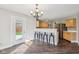 Inviting dining area featuring stylish chandelier and breakfast bar with barstool seating and a door to the fenced backyard at 10303 Memorial Knoll Dr, Indianapolis, IN 46234