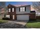 Charming two-story home with brick and siding, attached two-car garage, and driveway at 10303 Memorial Knoll Dr, Indianapolis, IN 46234