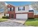 Inviting two-story home with brick facade, siding accents, and a well-maintained front lawn at 10303 Memorial Knoll Dr, Indianapolis, IN 46234